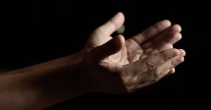 hands of women who raise their hands to pray for God's blessings